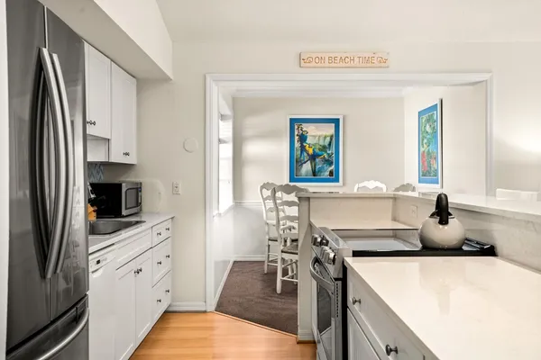 a kitchen with a stove a refrigerator and a sink