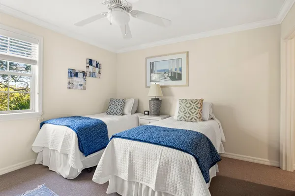 a bedroom with two beds and a window