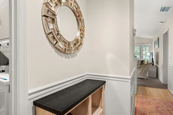 a view of a dining room with furniture a rug and wooden floor