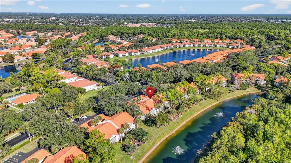 an aerial view of residential houses with outdoor space and trees