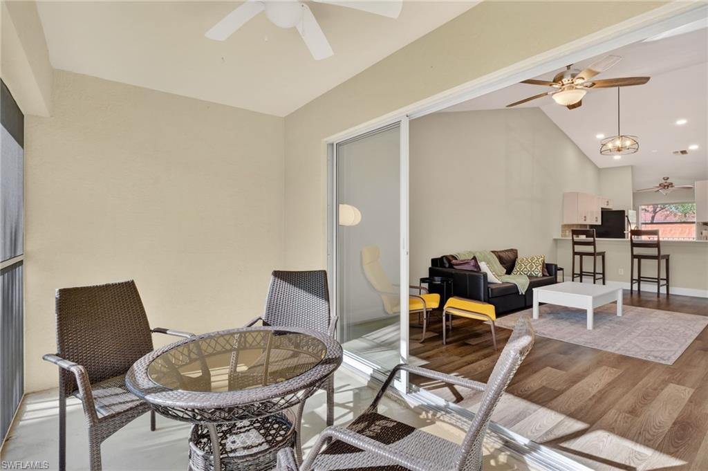 209 Robin Hood Circle, Unit 201 Naples, FL 34104 - Photo 12 of 29 a living room with furniture and wooden floor