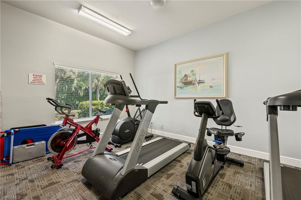 209 Robin Hood Circle, Unit 201 Naples, FL 34104 - Photo 20 of 29 a view of a room with gym equipment