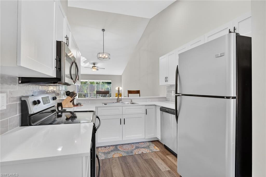 209 Robin Hood Circle, Unit 201 Naples, FL 34104 - Photo 2 of 29 a kitchen with stainless steel appliances a refrigerator sink and cabinets