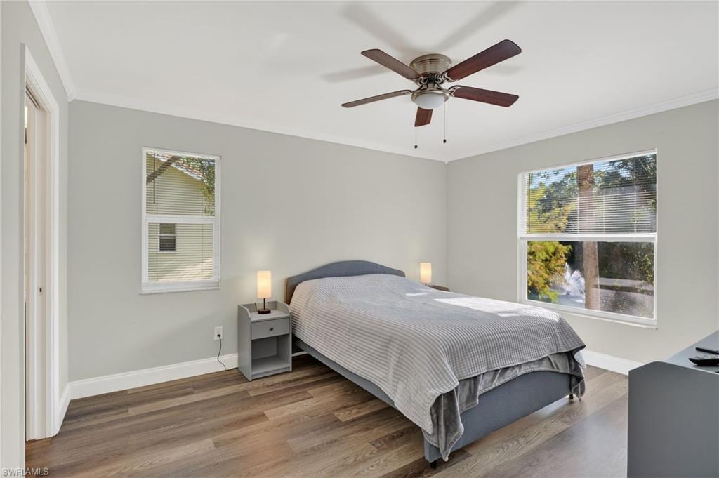 209 Robin Hood Circle, Unit 201 Naples, FL 34104 - Photo 8 of 29 a bedroom with a bed and window