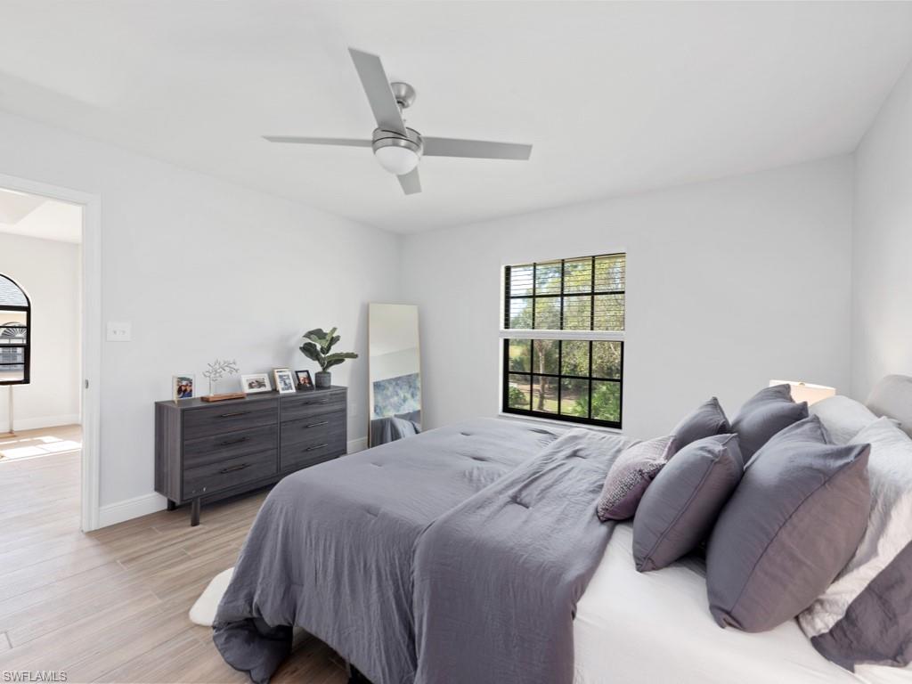 709 Augusta Boulevard, Unit 7095 Naples, FL 34113 - Photo 7 of 16 Bedroom with ceiling fan and light hardwood / wood-style flooring