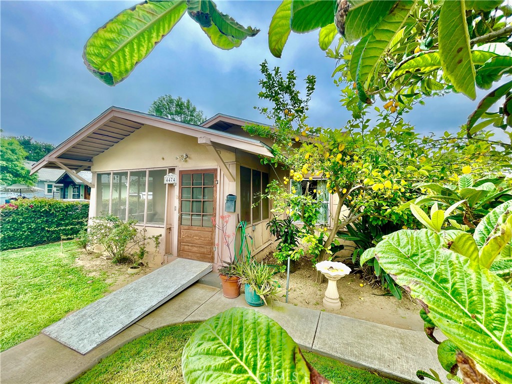 4474 Highland Place Riverside, CA 92506 - Photo 1 of 22 a front view of a house with garden