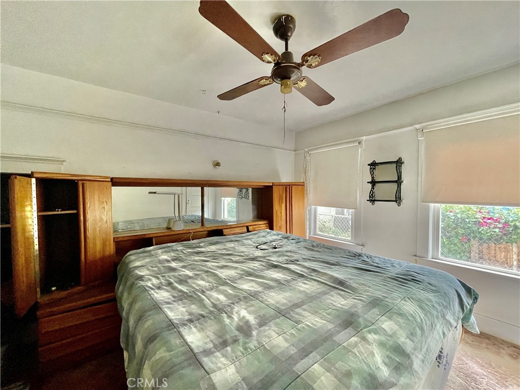 4474 Highland Place Riverside, CA 92506 - Photo 18 of 22 a bed sitting in a spacious bedroom next to a window