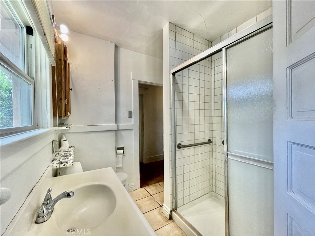 4474 Highland Place Riverside, CA 92506 - Photo 20 of 22 a bathroom with a sink and shower