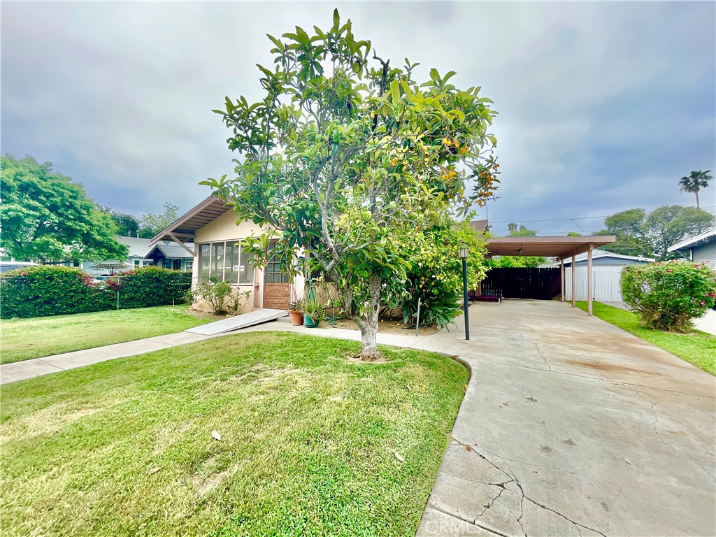 4474 Highland Place Riverside, CA 92506 - Photo 5 of 22 a front view of a house with a yard