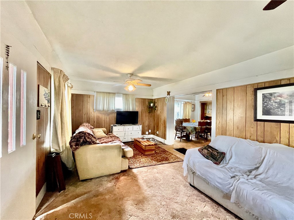 4474 Highland Place Riverside, CA 92506 - Photo 9 of 22 a living room with furniture windows and a flat screen tv