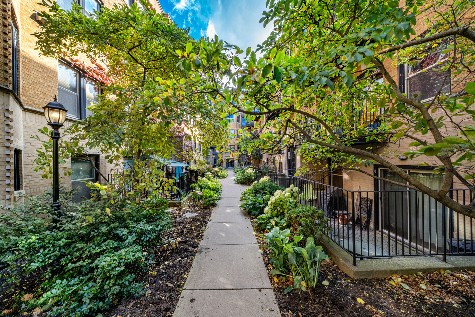 1225 West Greenleaf Avenue, Unit 3W Chicago, IL 60626 - Photo 1 of 13 a view of a pathway with a white house with wooden fence
