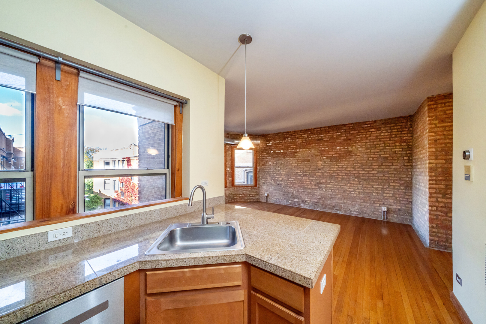 1225 West Greenleaf Avenue, Unit 3W Chicago, IL 60626 - Photo 5 of 13 a kitchen with a sink and a large window