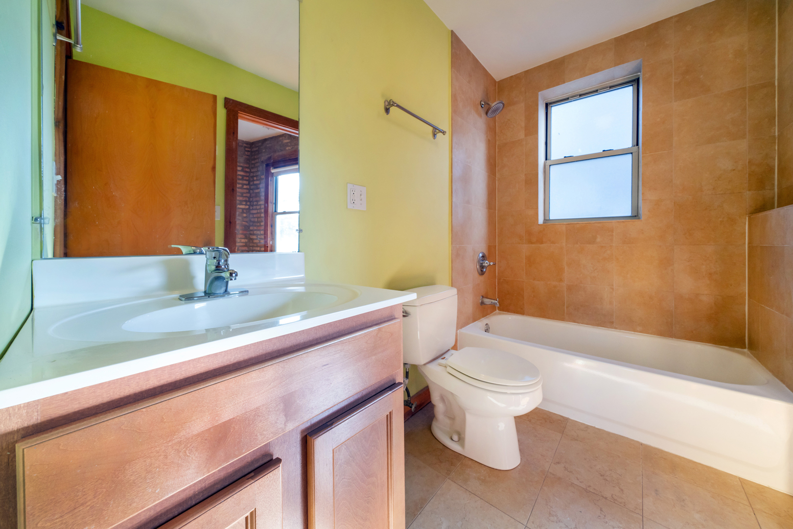 1225 West Greenleaf Avenue, Unit 3W Chicago, IL 60626 - Photo 10 of 13 a bathroom with a sink a toilet and shower