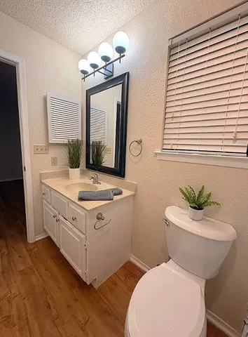 a bathroom with a toilet sink and mirror