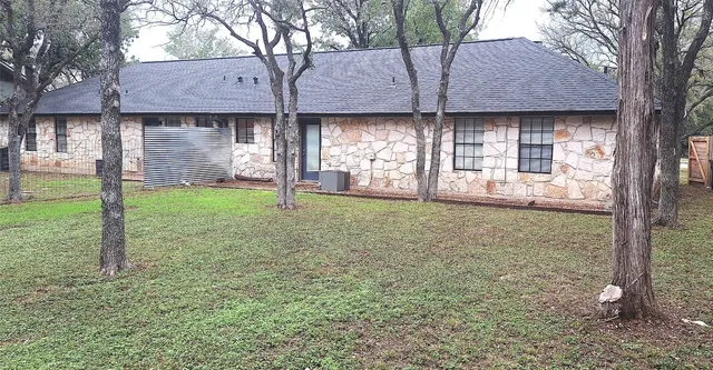 a view of a house with a yard and sitting area