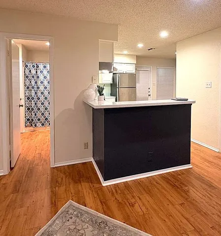 a view of kitchen with wooden floor