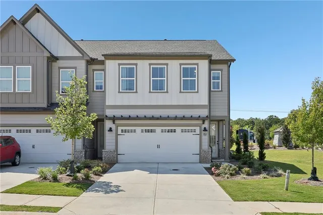 a front view of a house with a garden