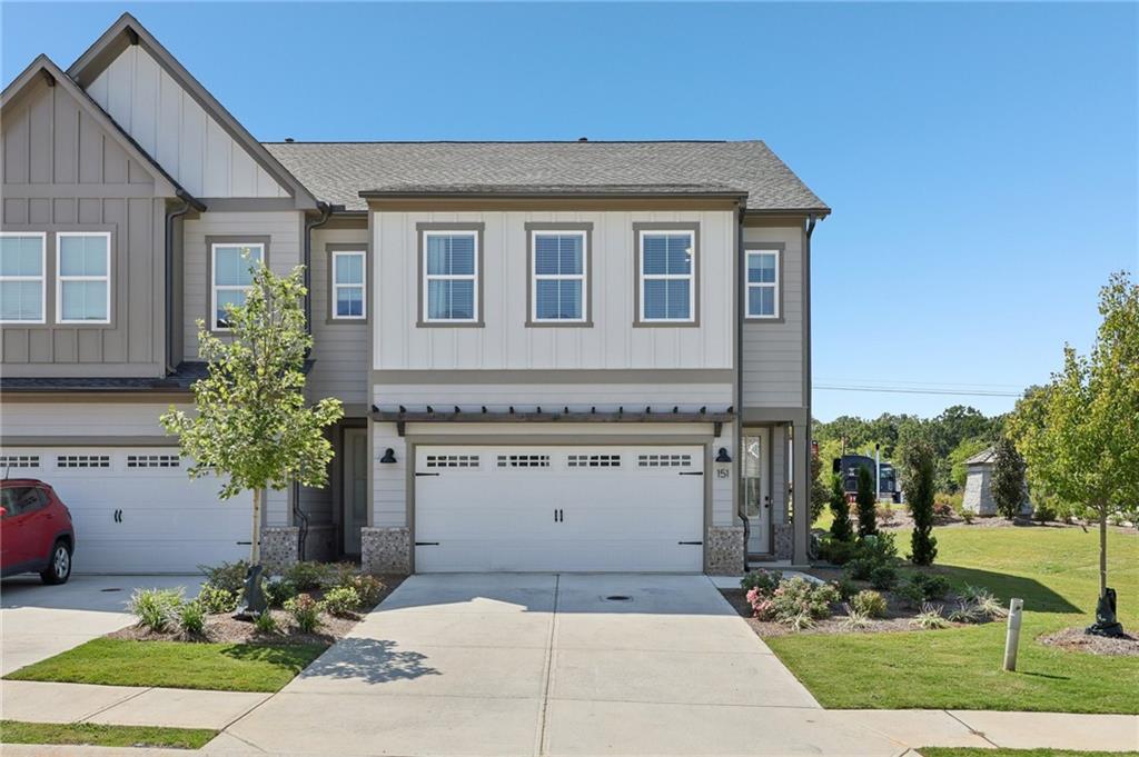 a front view of a house with a garden