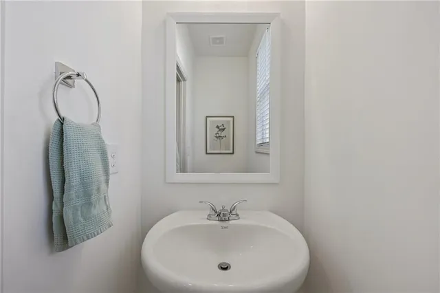 a spacious bathroom with a granite countertop sink a mirror and a shower