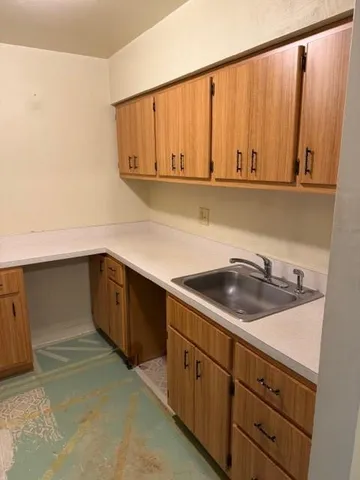 a kitchen with a sink and cabinets