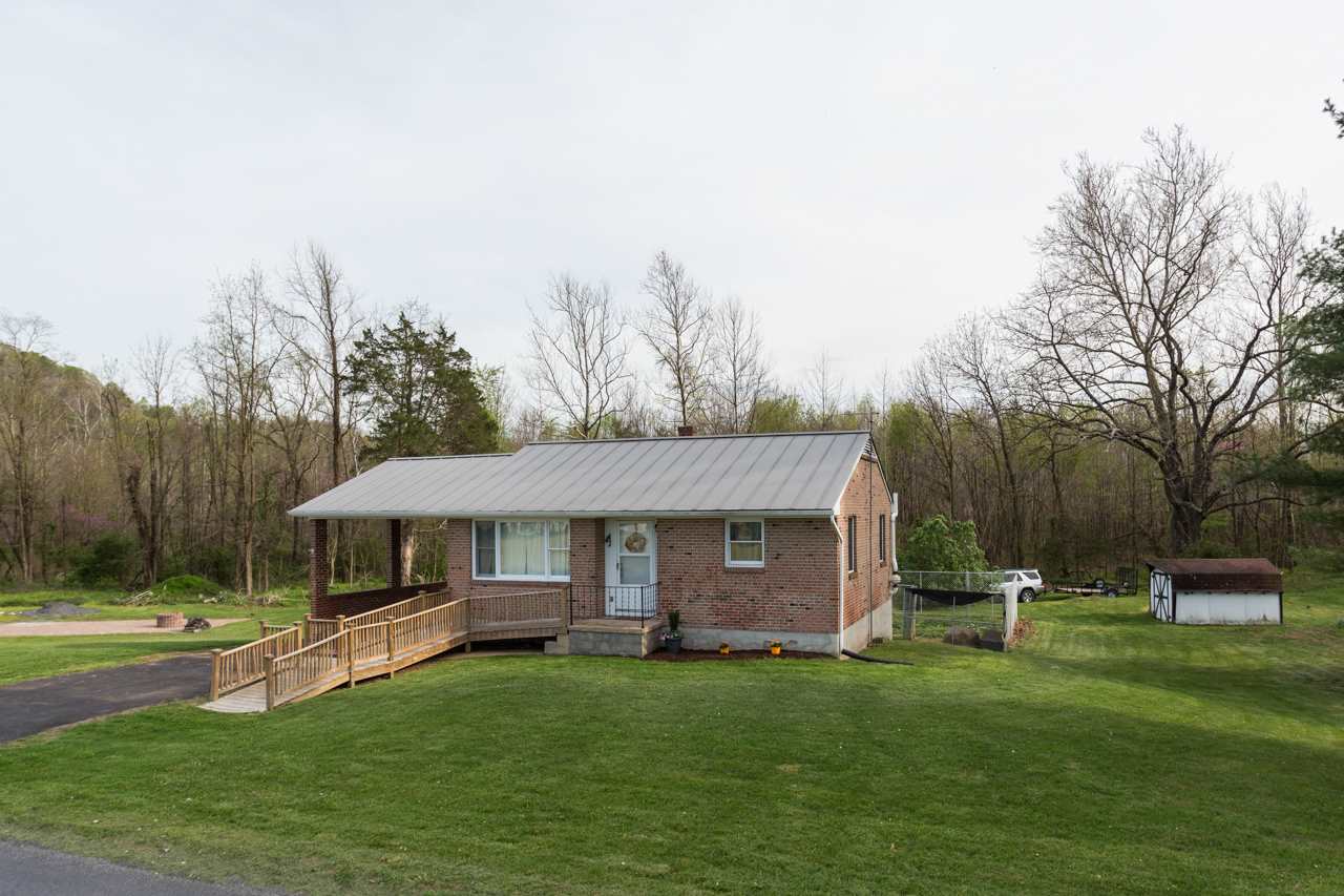 1119 North River Road Mount Solon, VA 22843 - Photo 17 of 24 a front view of a house with a garden