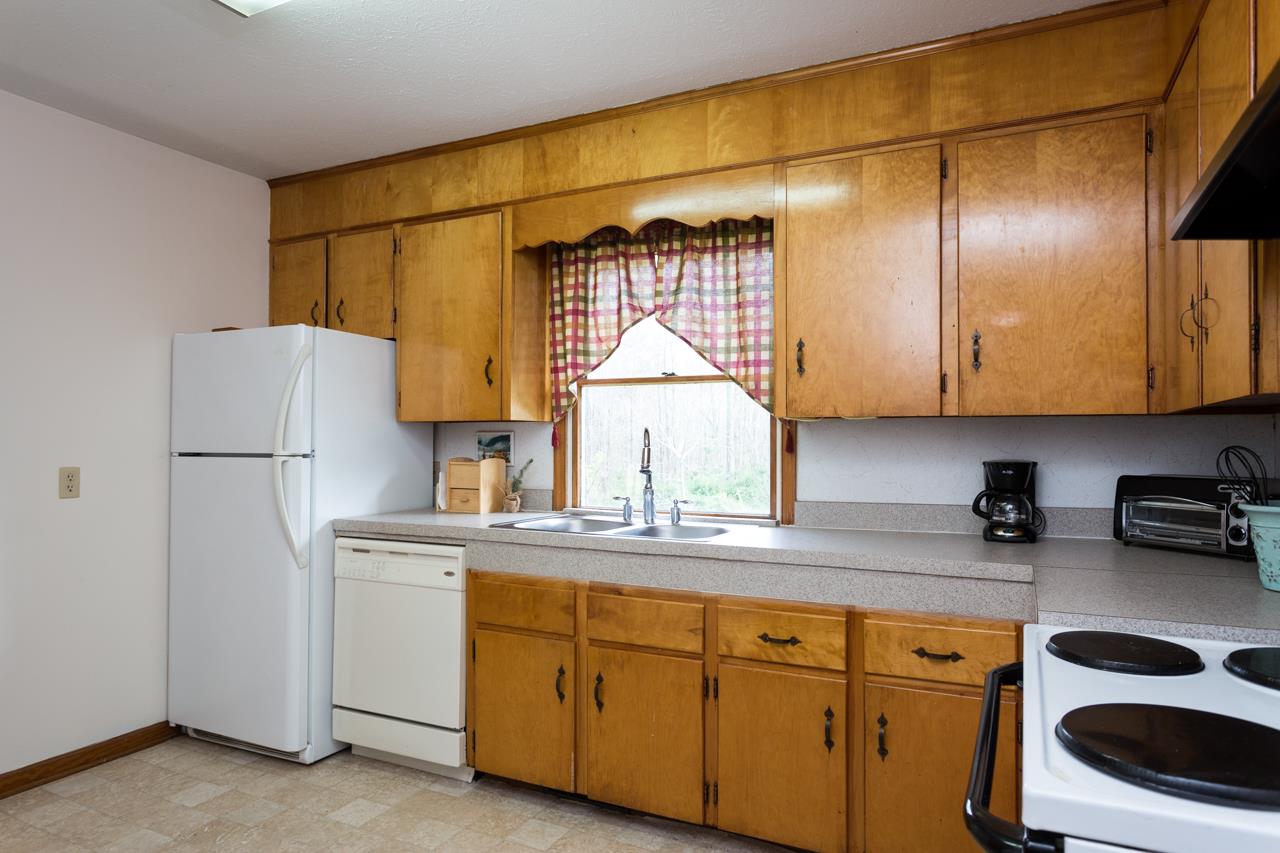 1119 North River Road Mount Solon, VA 22843 - Photo 3 of 24 a kitchen with a sink a refrigerator and cabinets