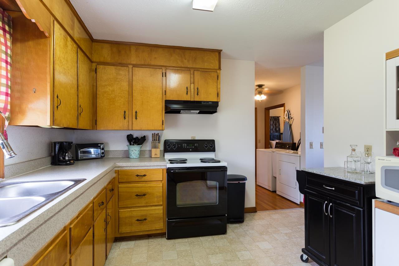 1119 North River Road Mount Solon, VA 22843 - Photo 4 of 24 a kitchen with a sink stove and cabinets