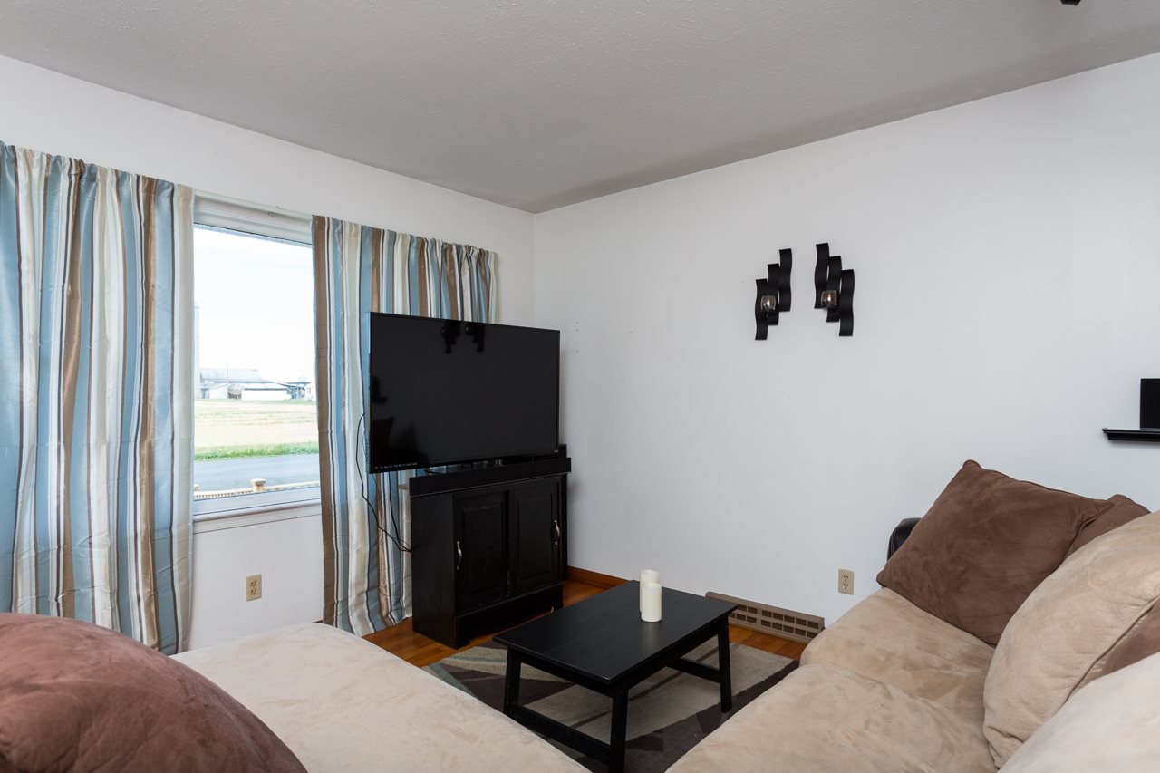 1119 North River Road Mount Solon, VA 22843 - Photo 7 of 24 a living room with a bed furniture and a flat tv screen