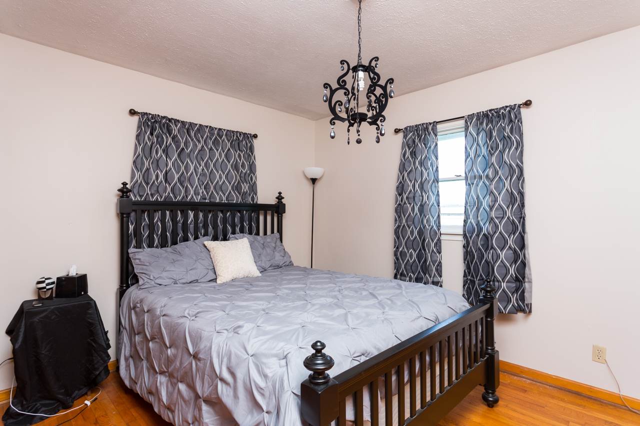1119 North River Road Mount Solon, VA 22843 - Photo 8 of 24 a bedroom with a bed and a chandelier