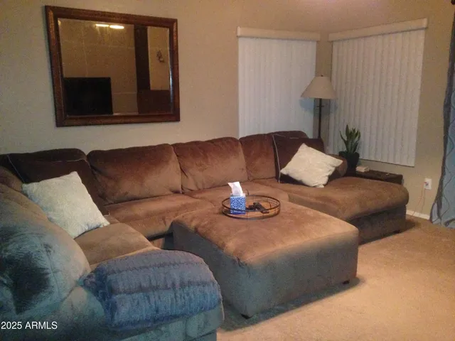 a living room with furniture and a mirror