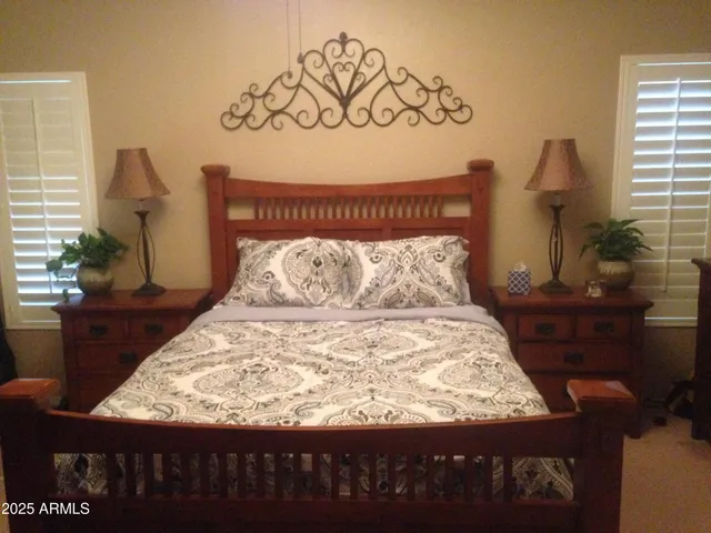 a large bed sitting in a bedroom next to a window