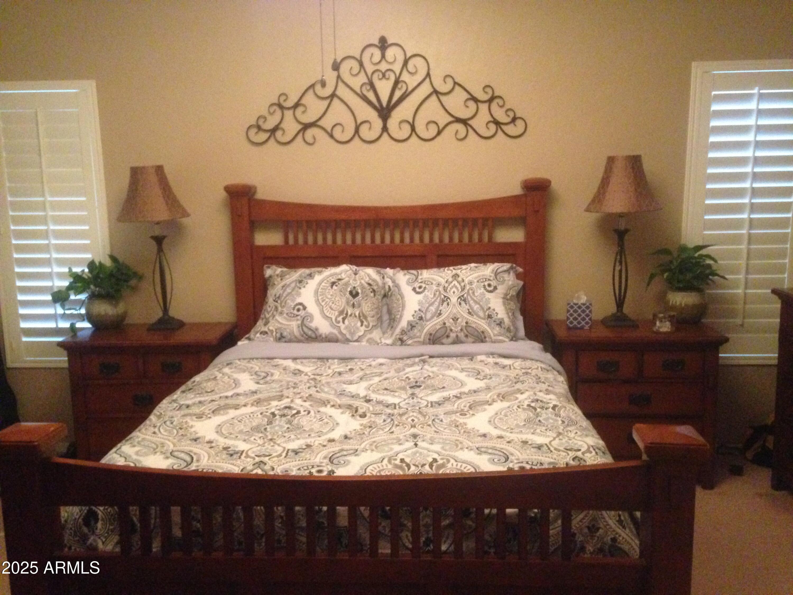 861 South Honeysuckle Lane Gilbert, AZ 85296 - Photo 6 of 10 a large bed sitting in a bedroom next to a window