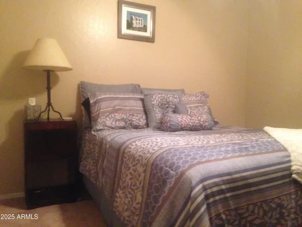a bedroom with a bed and a lamp