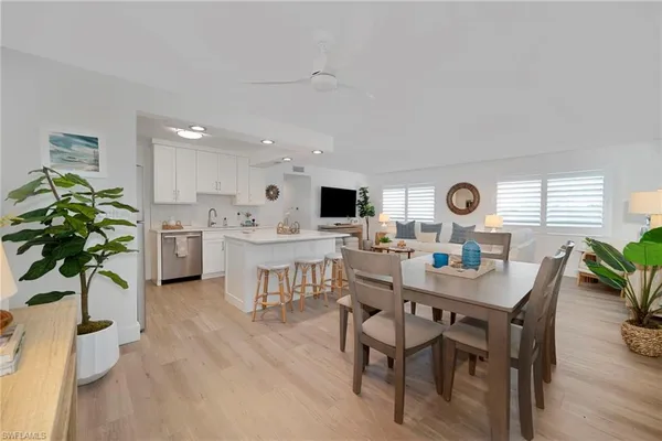 a view of a dining room with furniture and a potted plant