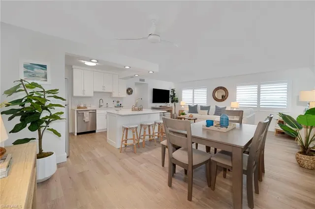 a view of a dining room with furniture and a potted plant