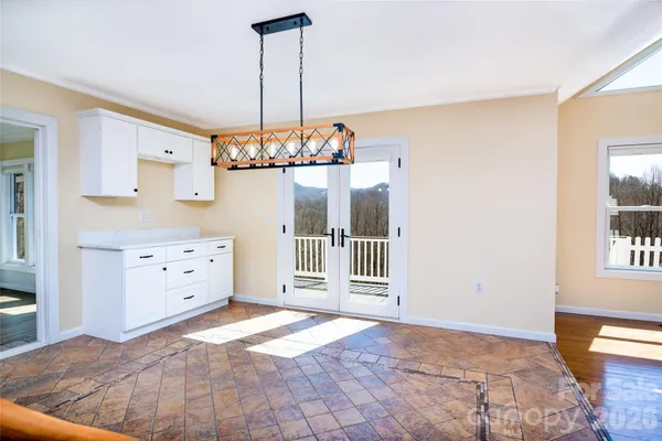 a view of a bedroom with cabinet and windows