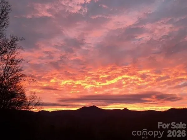 a view of a balcony with wooden floor and outdoor seating