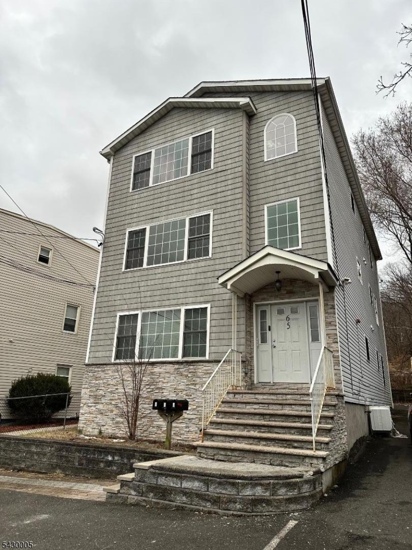 63 Garret Street, Unit 2 Paterson, NJ 07501 - Photo 1 of 9 a front view of a house with a yard