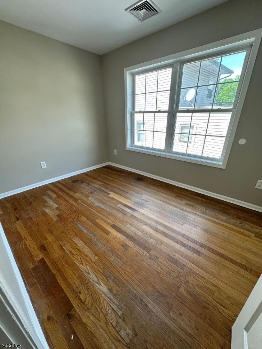 63 Garret Street, Unit 2 Paterson, NJ 07501 - Photo 3 of 9 a view of an empty room with a window