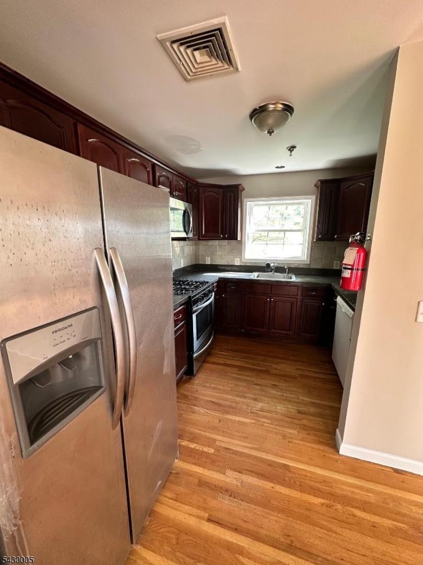 63 Garret Street, Unit 2 Paterson, NJ 07501 - Photo 5 of 9 a kitchen with stainless steel appliances granite countertop a refrigerator and a sink