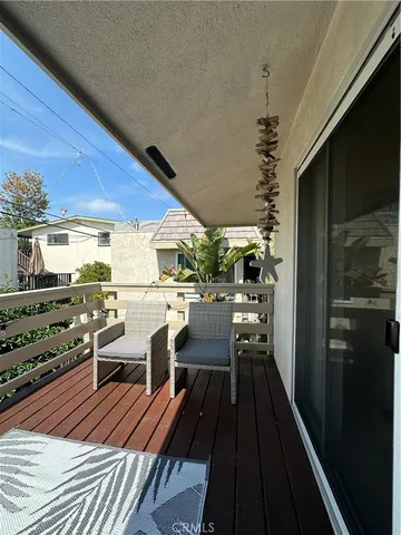 a view of a patio with table and chairs a barbeque with wooden floor and fence