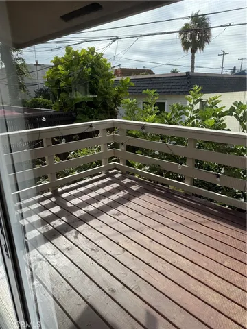a view of a balcony with chair and wooden floor