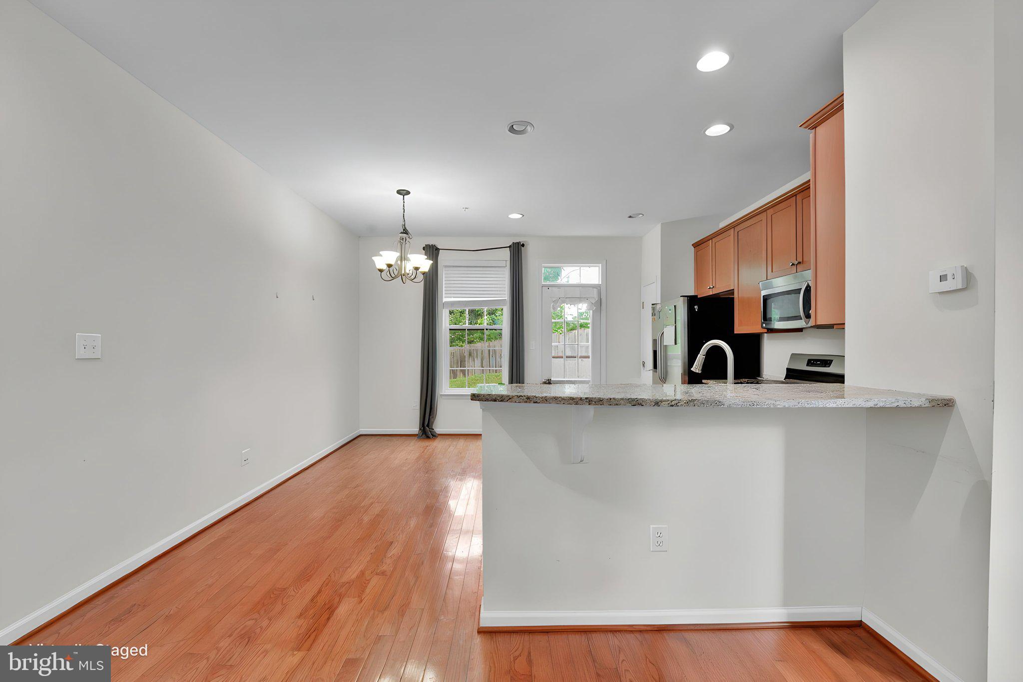 7138 Station House Road Elkridge, MD 21075 - Photo 23 of 42 a view of kitchen with window and wooden floor