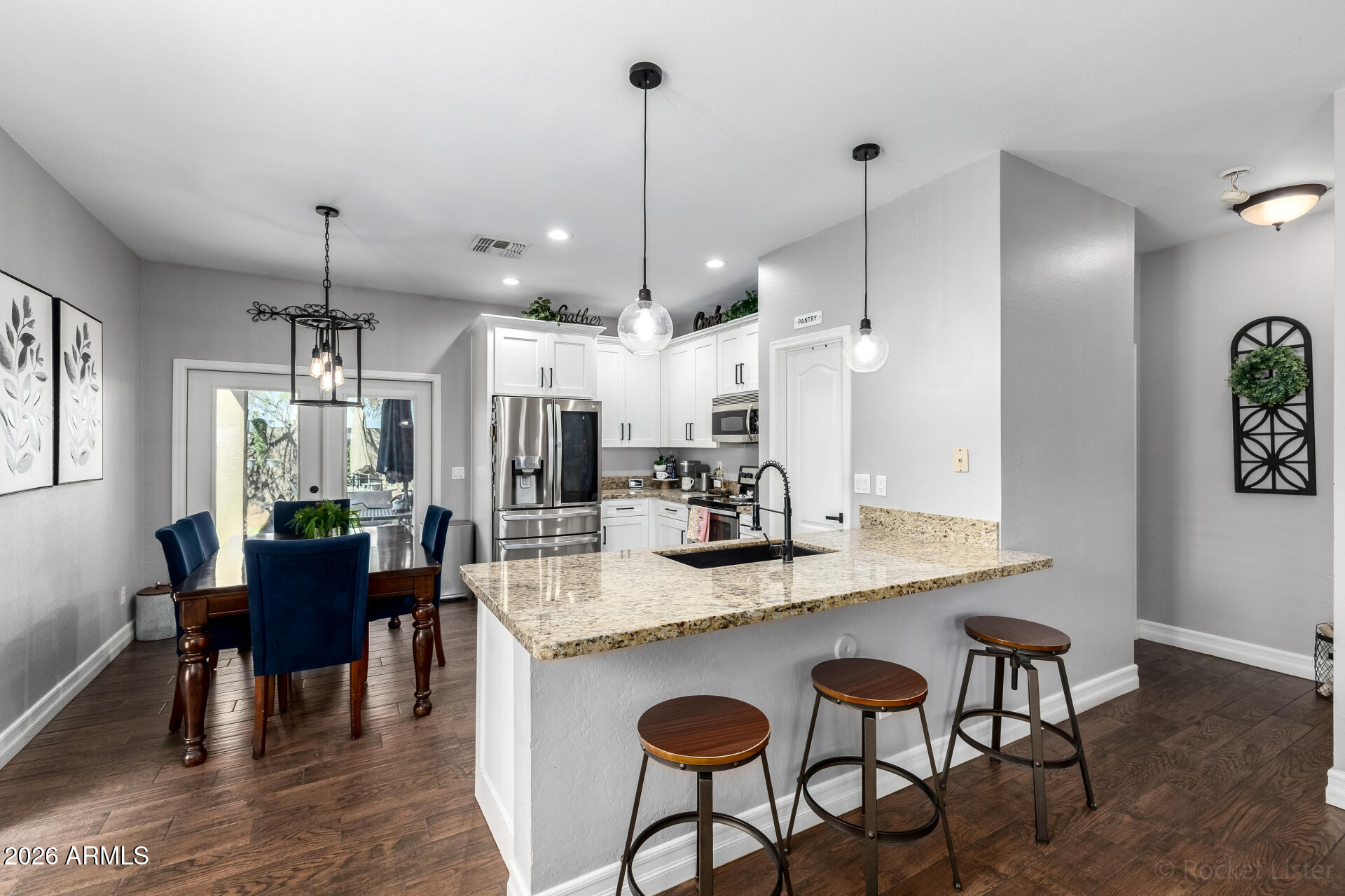 9646 West Payson Road Tolleson, AZ 85353 - Photo 15 of 36 a kitchen with granite countertop white cabinets and stainless steel appliances