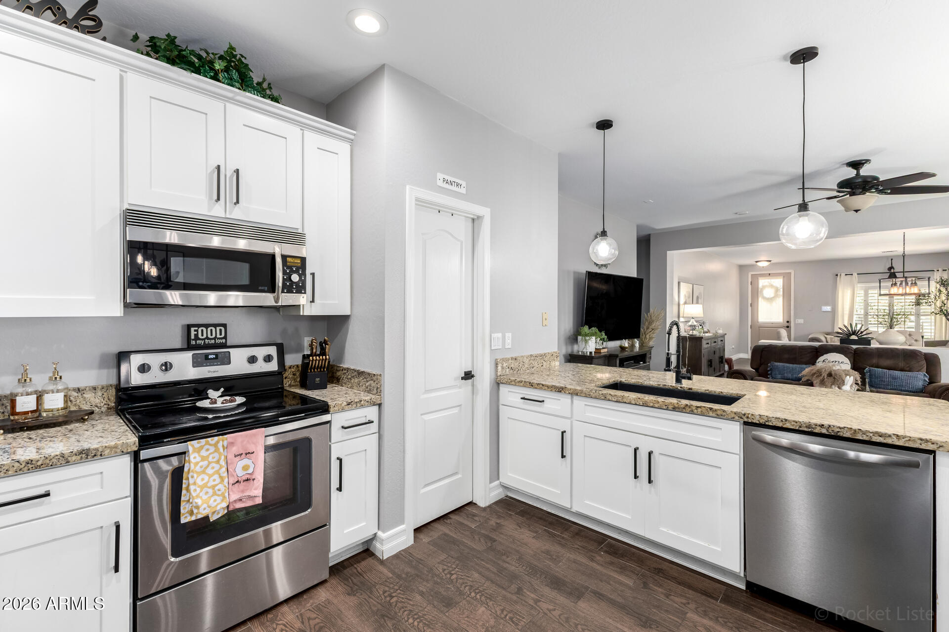 9646 West Payson Road Tolleson, AZ 85353 - Photo 16 of 36 a kitchen with stainless steel appliances granite countertop a stove a sink and a microwave