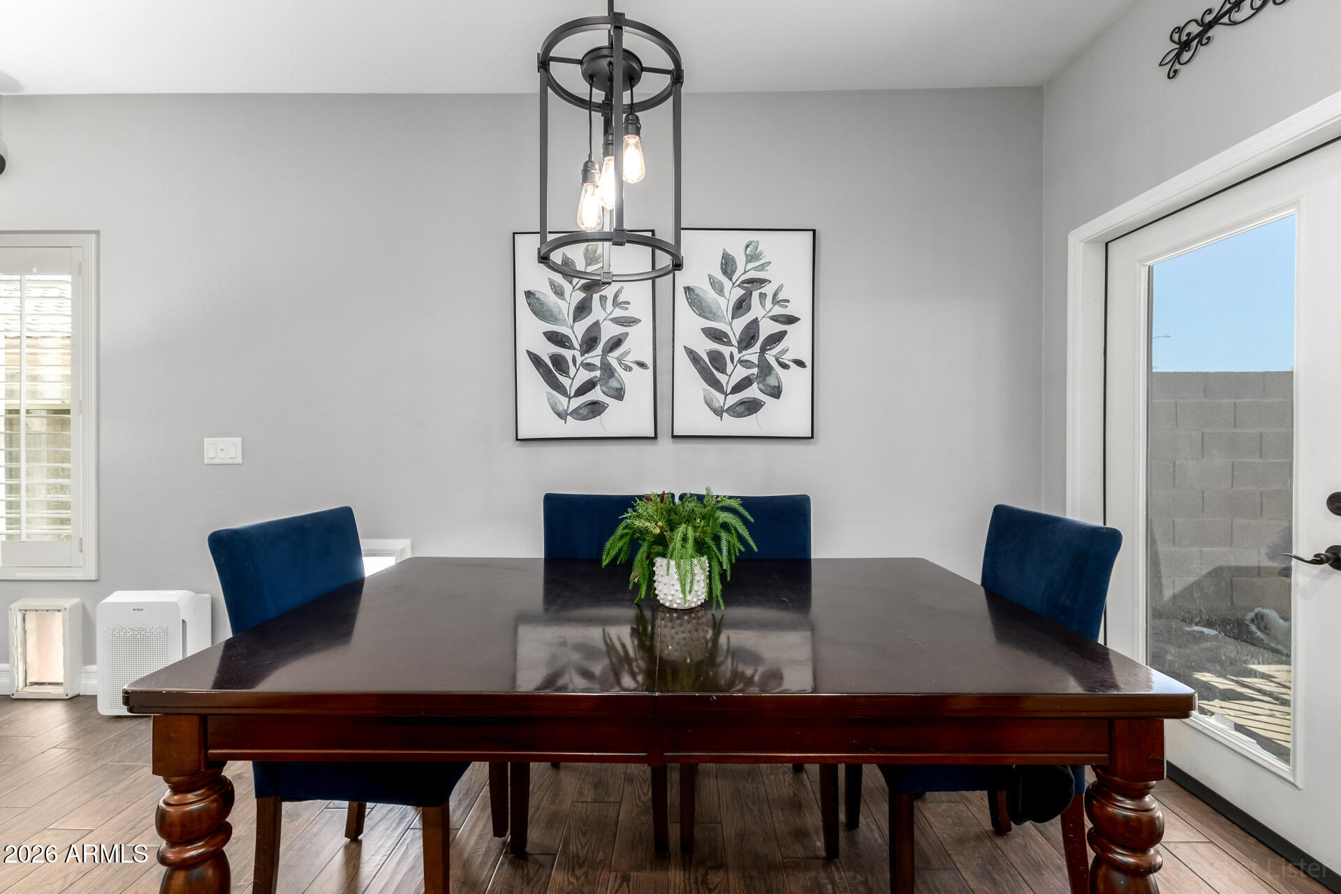 9646 West Payson Road Tolleson, AZ 85353 - Photo 18 of 36 a view of a dining room with furniture and wooden floor