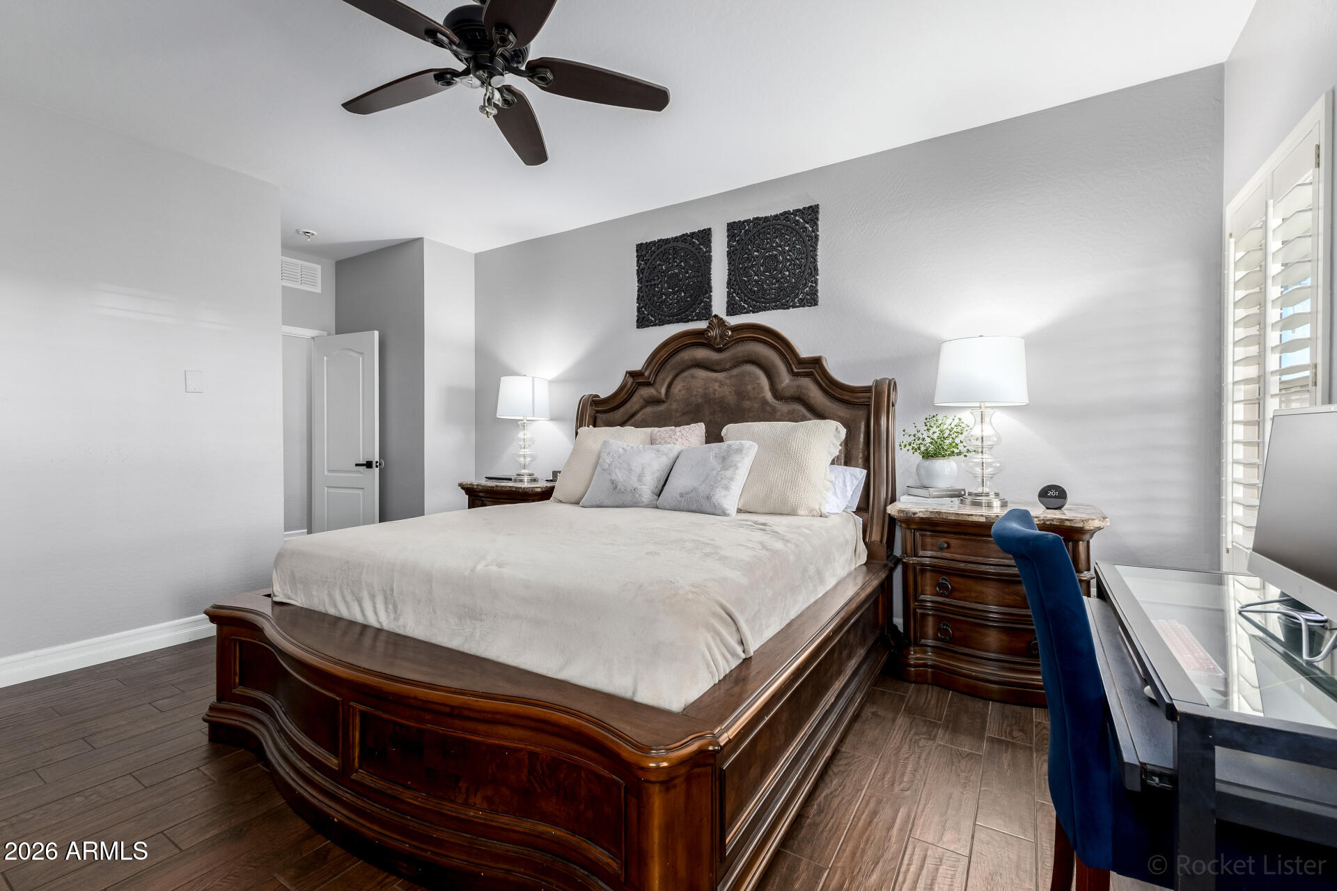 9646 West Payson Road Tolleson, AZ 85353 - Photo 21 of 36 a bedroom with a bed and a chandelier