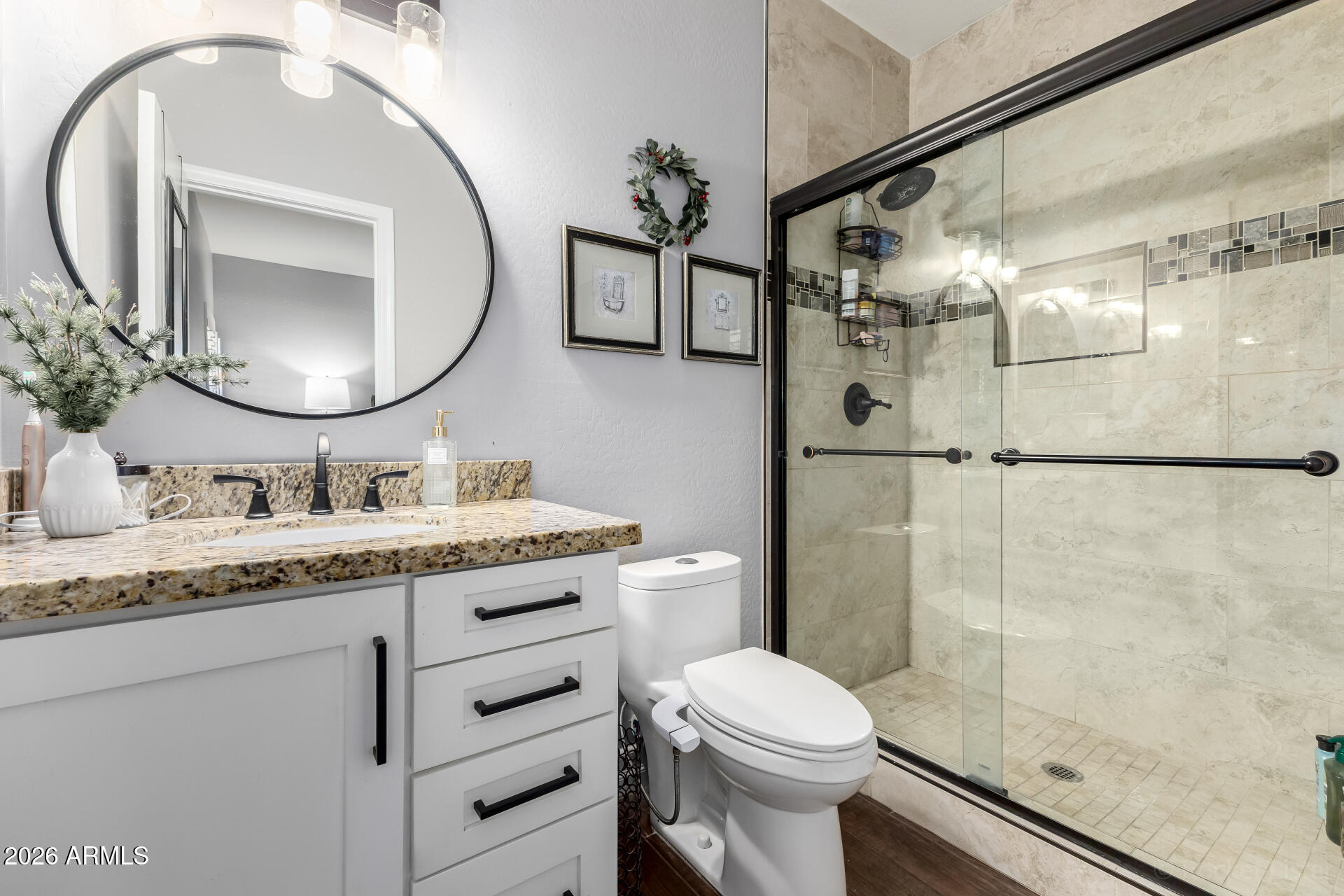 9646 West Payson Road Tolleson, AZ 85353 - Photo 22 of 36 a bathroom with a granite countertop sink mirror vanity and toilet