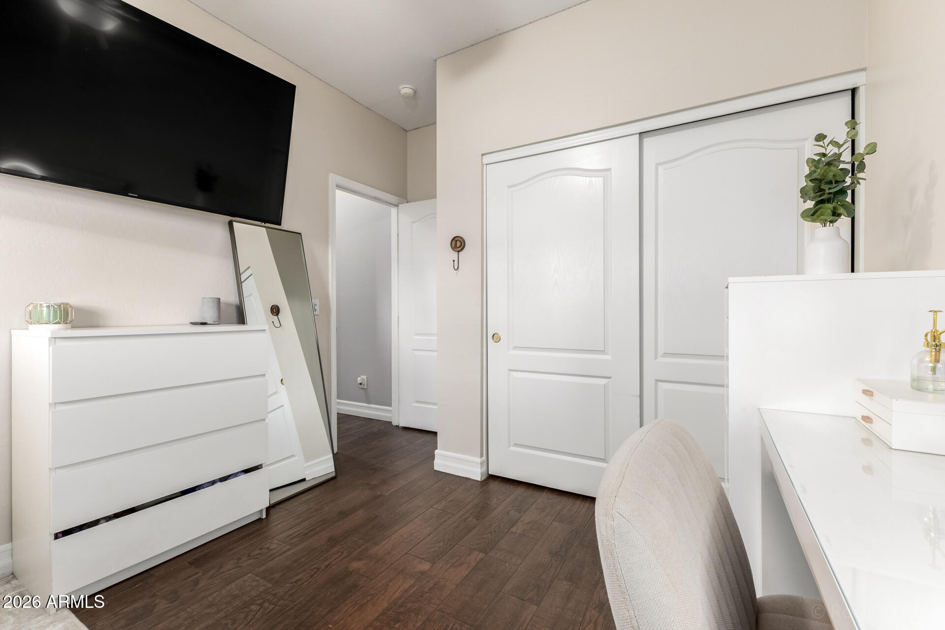 9646 West Payson Road Tolleson, AZ 85353 - Photo 25 of 36 a room with a white bed furniture and wooden floor