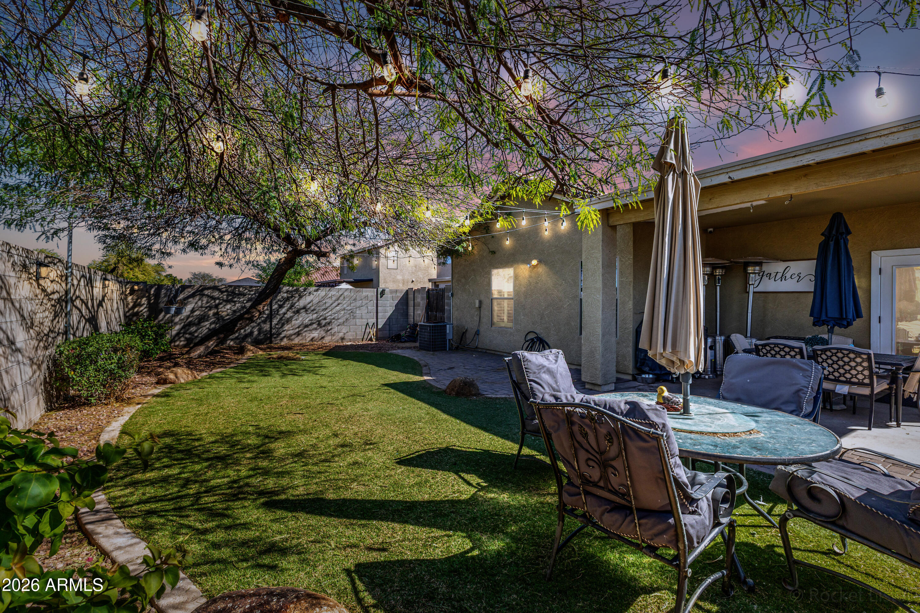 9646 West Payson Road Tolleson, AZ 85353 - Photo 31 of 36 a view of a chairs and table in backyard